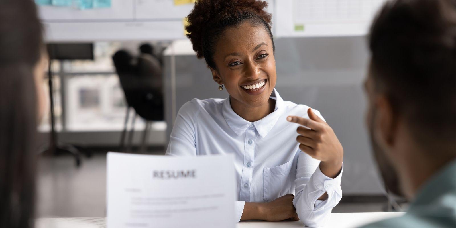 Woman in an interview answering questions and feeling positive about the outcome.